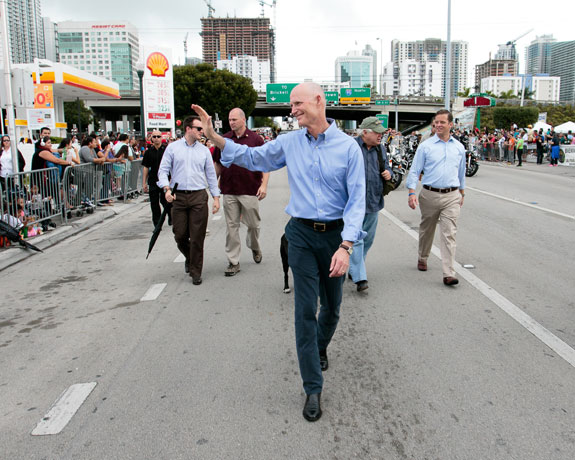 Gov. Rick Scott, pictured here walking in Miami during the annual Three Kings Parade, has ordered a prohibition on the terms “climate change” and “global warming.” Low-lying Miami is among the U.S. cities most vulnerable to sea-level rise. (Photo courtesy of Gov. Rick Scott.)