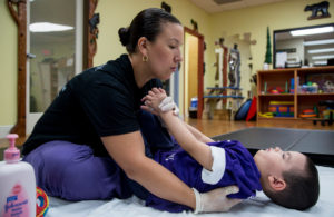 Physical therapist Cynthia Espinal exercises Bruno Stillo, 4, at B&V Thera-Pro in Miami. Stillo suffers from Dravet syndrome, a rare form of intractable epilepsy. (Photo by Nick Swyter.)