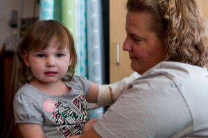 Julie Michaels and her daughter, Sydney, 5, prepare to go home after spending a couple of days at the Children's Hospital of Pittsburgh. Sydney is one of a few children enrolled in a clinical trial for Epidiolex. (Photo by Calah Kelley.)